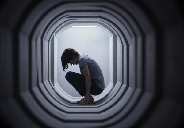 Person feeling overwhelmed, world shrinking due to fear